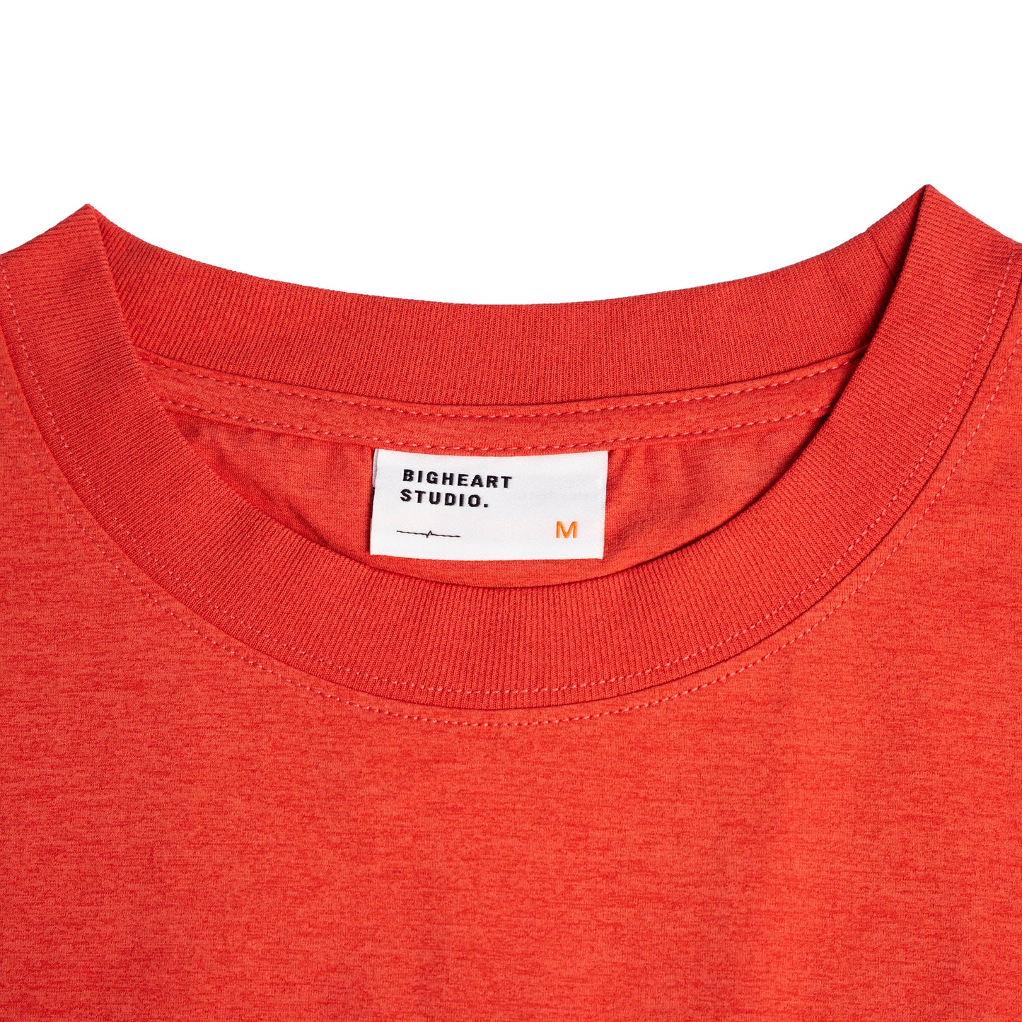 Close-up of a red shirt with a brand label on a white background