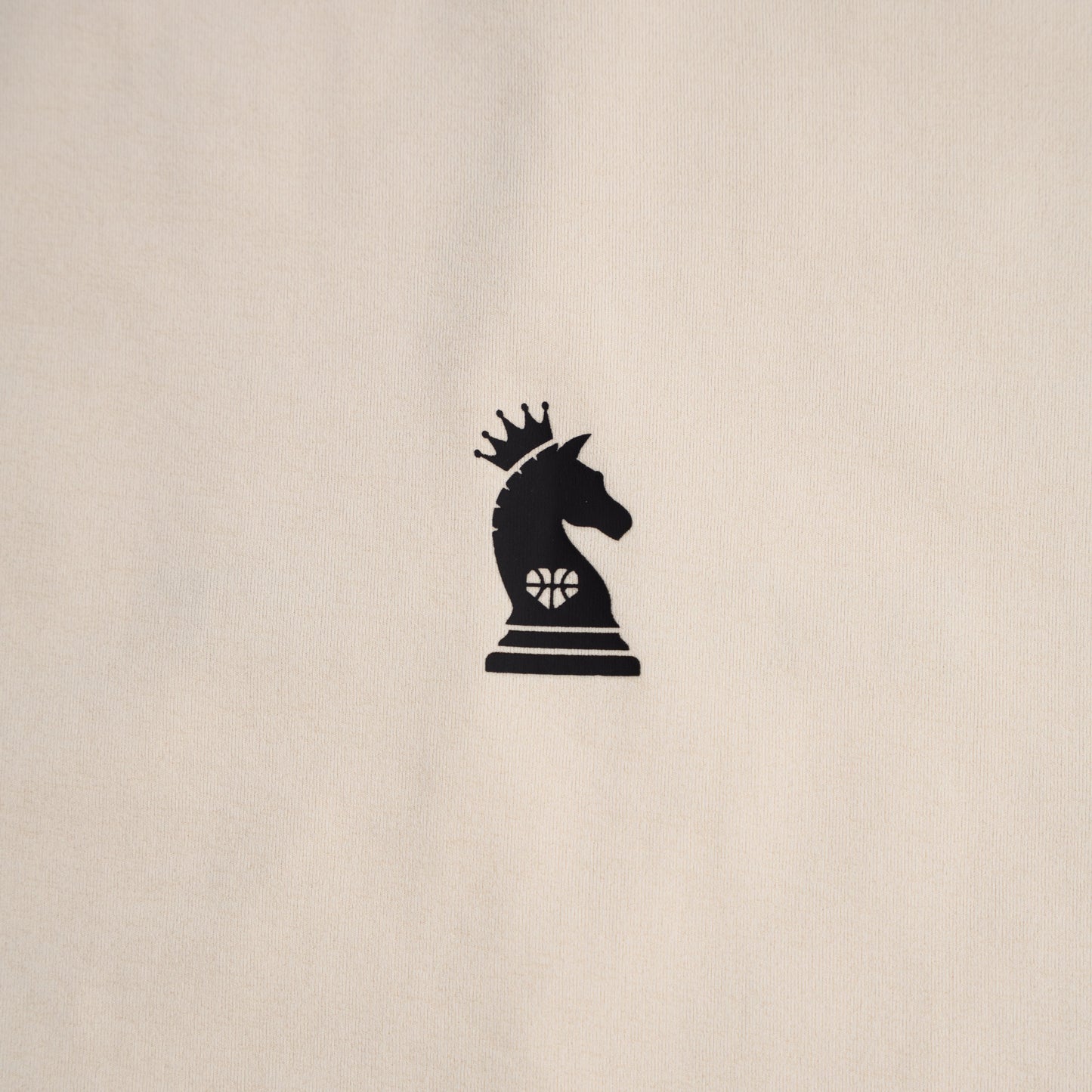Black chess piece with a crown on a beige background