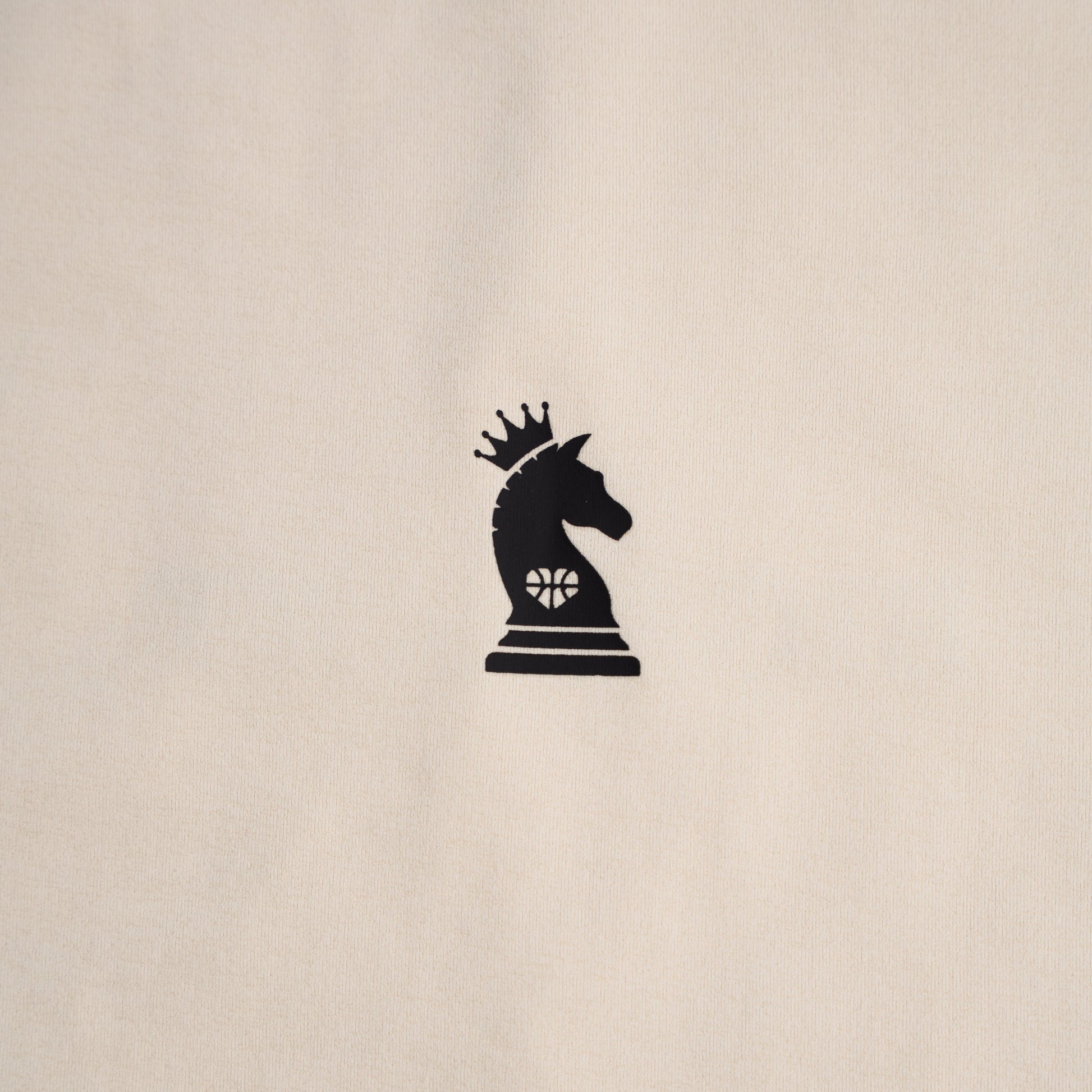 Black chess piece with a crown on a beige background
