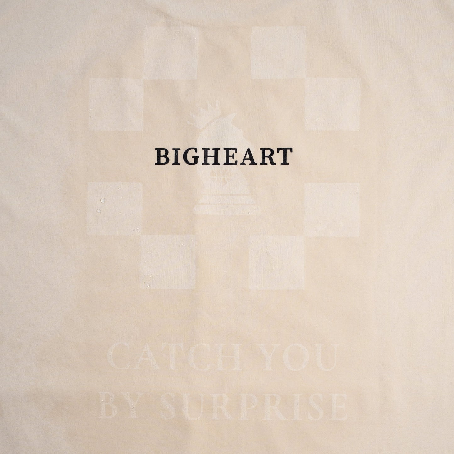 Ivory shirt with 'BIGHEART' text on a plain background