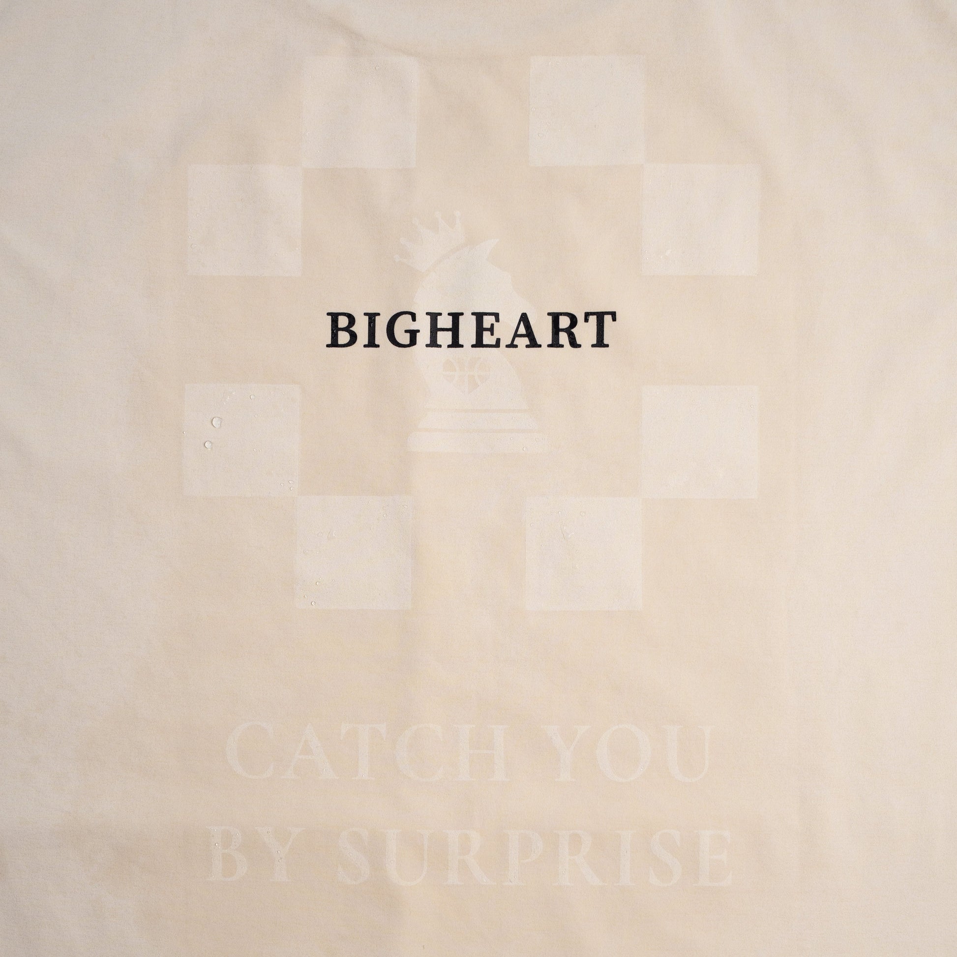 Ivory shirt with 'BIGHEART' text on a plain background