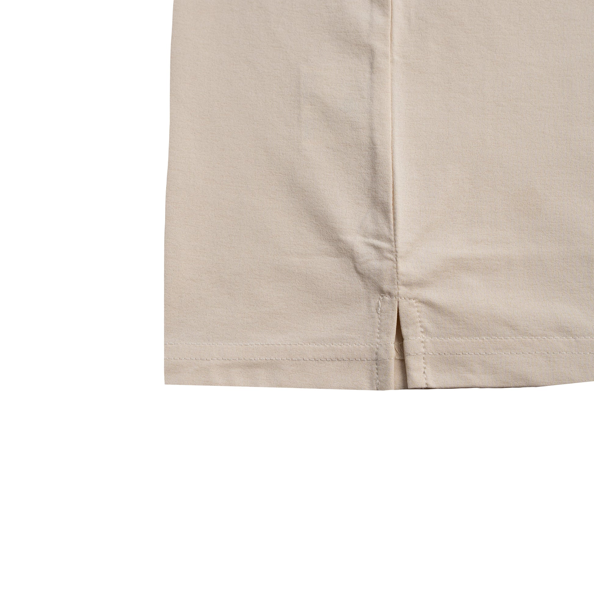 Close-up of beige tee on a white background